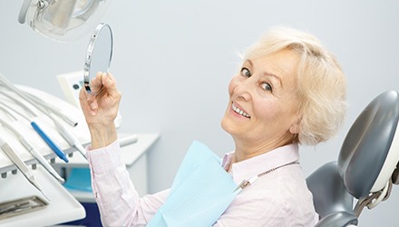 Older woman in dental chair smiling