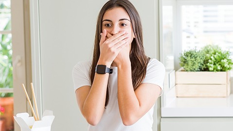 Woman covering her mouth