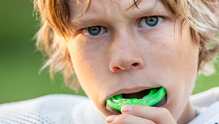 Teen boy placing green sportsguard