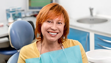 Older woman in dental chair smiling