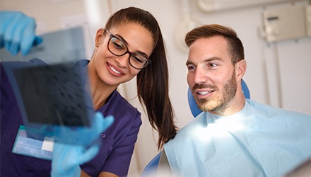 Dentist and patient looking at x-rays