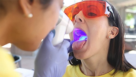 Woman receiving oral cancer screening