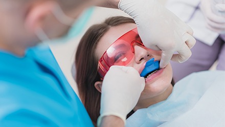 Young woman receiving fluoride treatment