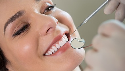 Woman with healthy teeth and gums during dental treatment