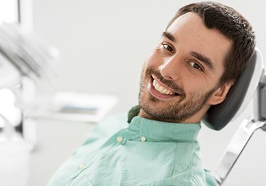 Man in dental chair smiling