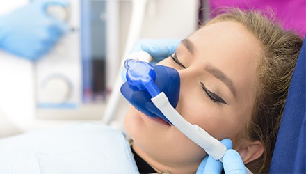 Woman with nitrous oxide nose mask